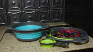 collapsible strainers and measuring cups sitting on a kitchen counter