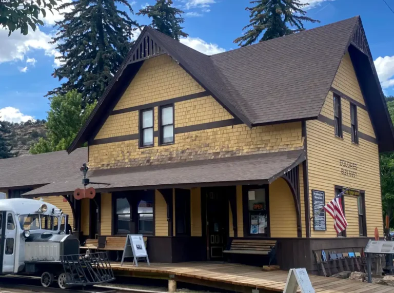 The historic Dolores train depot standing tall along the square