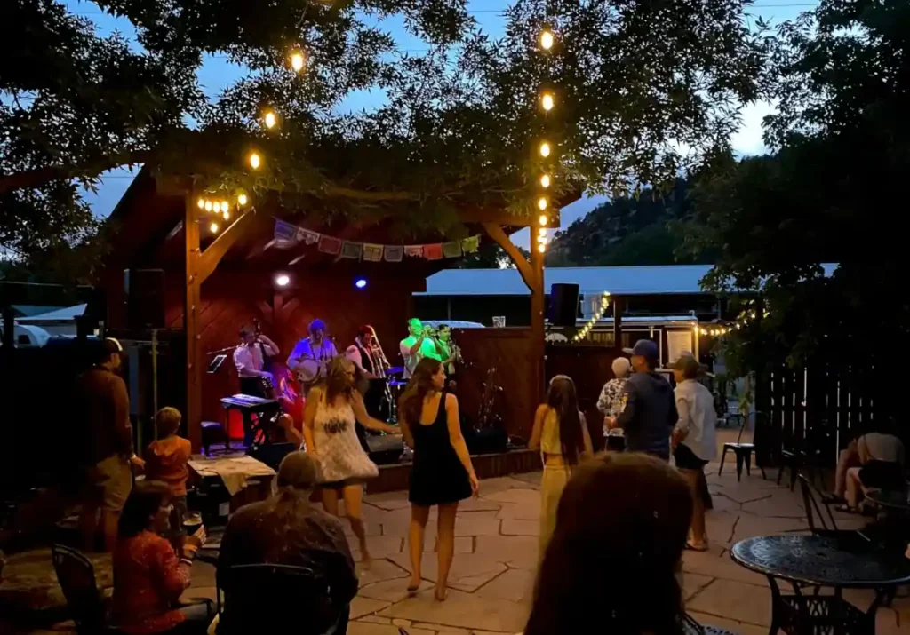 A crowd of people are enjoying live music on an outdoor patio