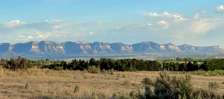 Mesa Verde rises dramatically from the high plains lit by the afternoon sun
